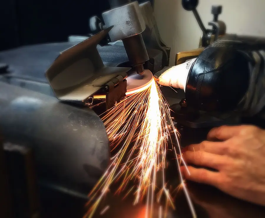 Sparks flying as a skate blade is sharpened at No Sweat